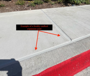 Am image showing a freshly caulked sidewalk